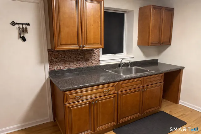 a kitchen with granite countertop cabinets and window
