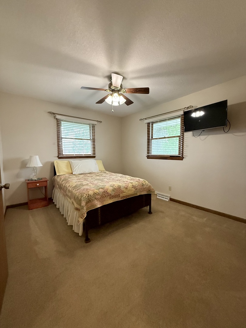 203 West Summit Street Gifford, IL 61847 - Photo 12 of 22 a bedroom with a bed and a ceiling fan