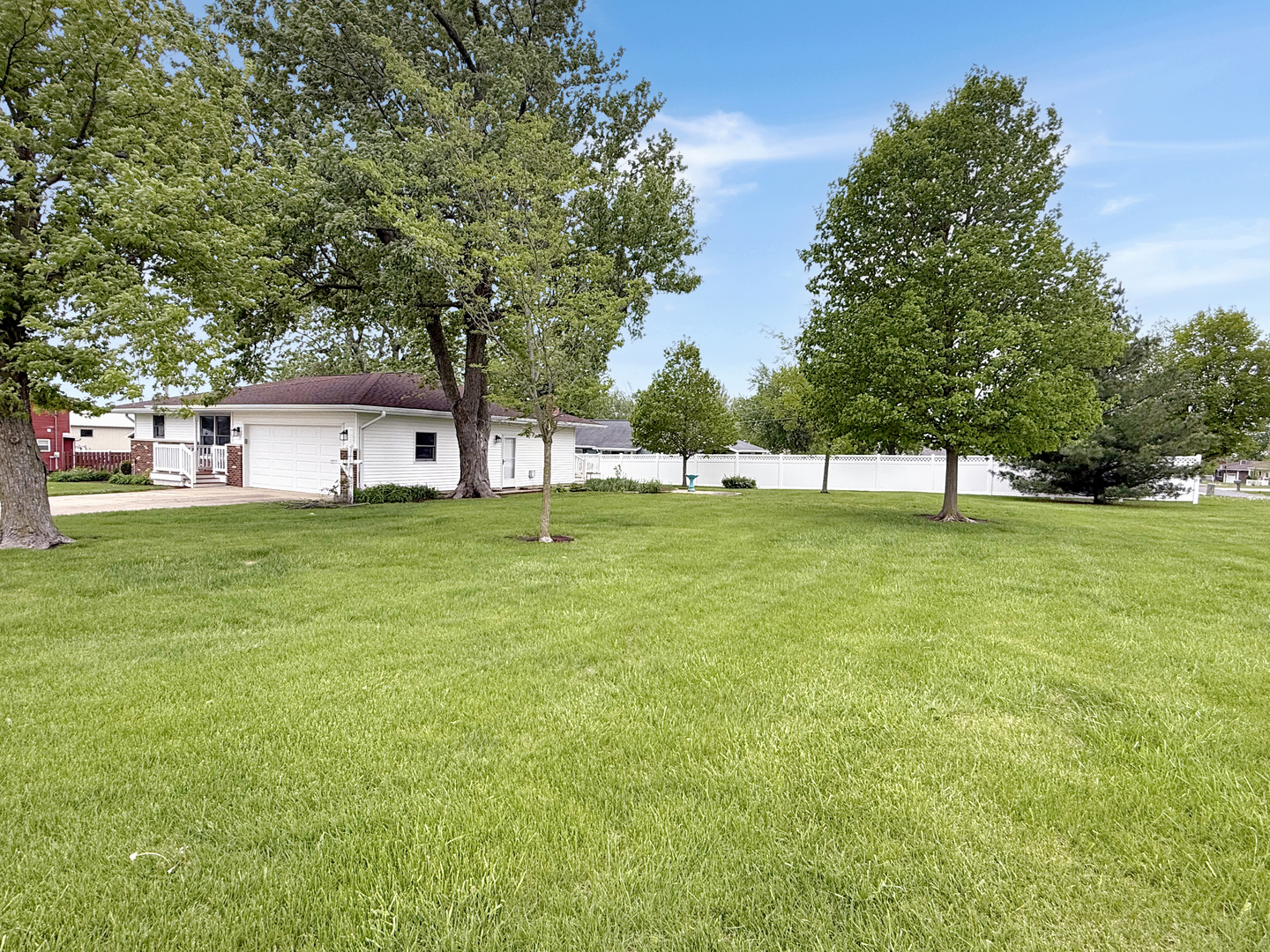 203 West Summit Street Gifford, IL 61847 - Photo 22 of 22 a view of a big yard with a bench and trees