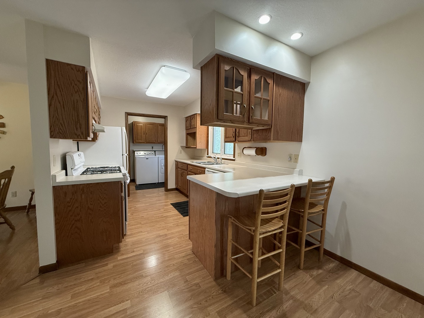 203 West Summit Street Gifford, IL 61847 - Photo 5 of 22 a kitchen with cabinets a sink and chairs in it