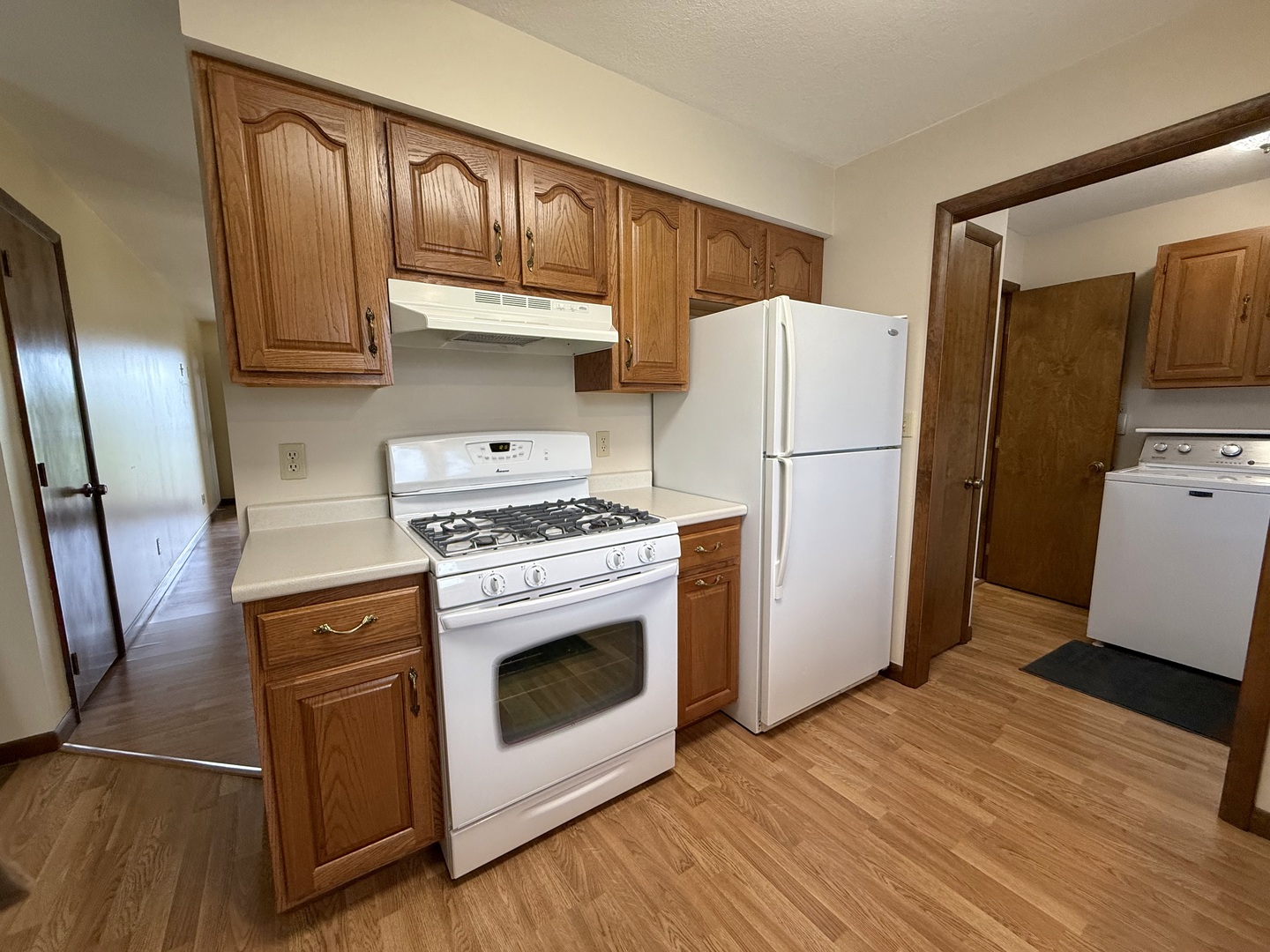 203 West Summit Street Gifford, IL 61847 - Photo 8 of 22 a kitchen with a refrigerator stove and wooden floor