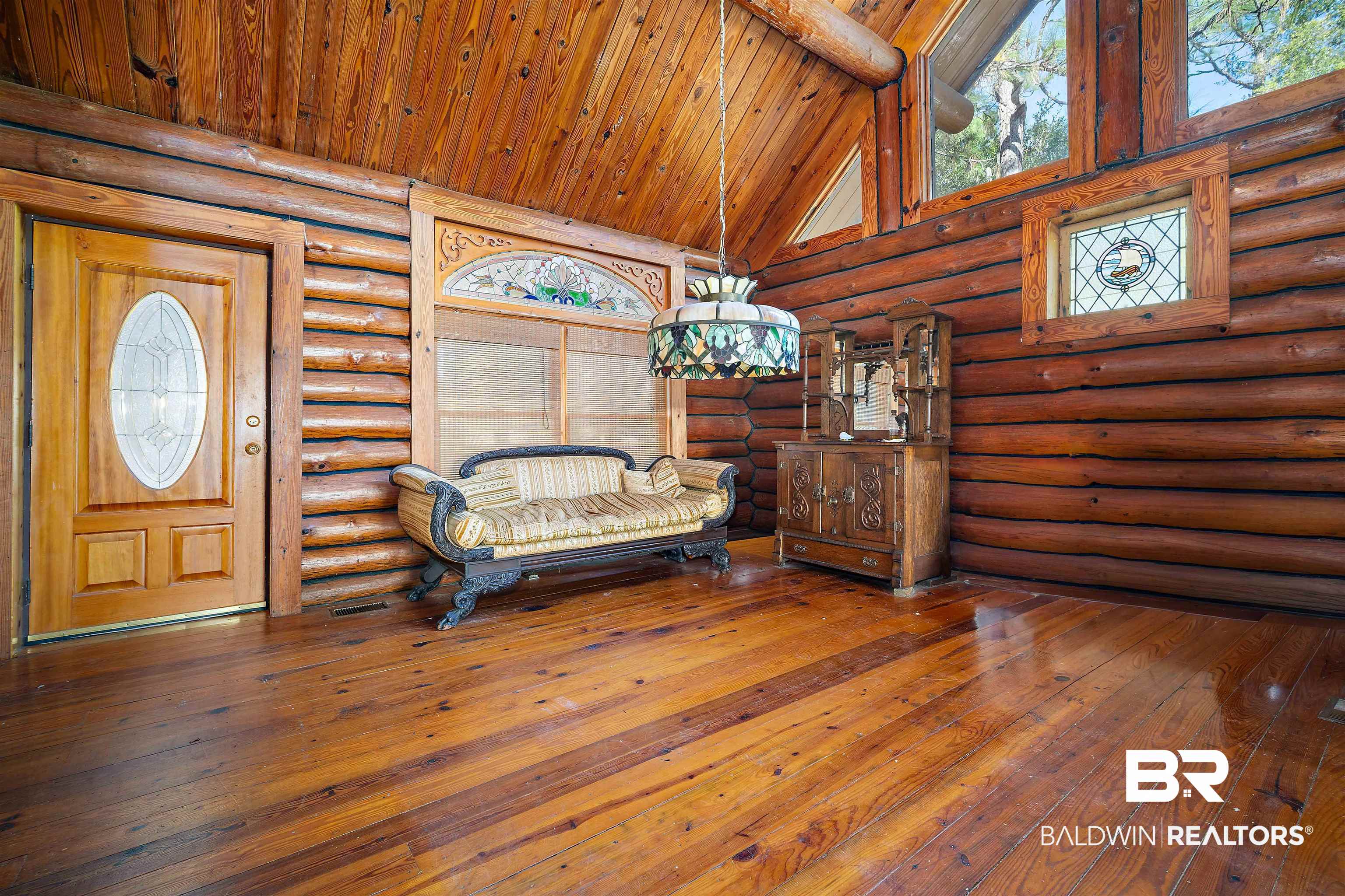 11236 Wren Avenue Fairhope, AL 36532 - Photo 7 of 35 Entryway featuring wood-type flooring, high vaulted ceiling, a wood ceiling with exposed beams, and rustic walls