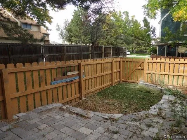 a view of a wooden fence and a yard