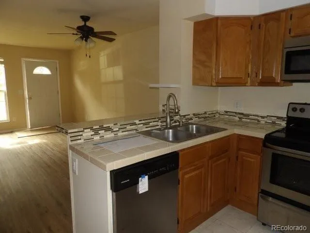 a kitchen with a sink stove and microwave