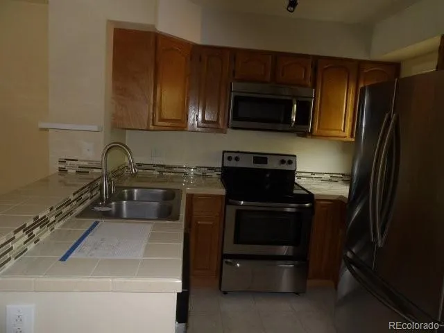 a kitchen with a sink stove and microwave