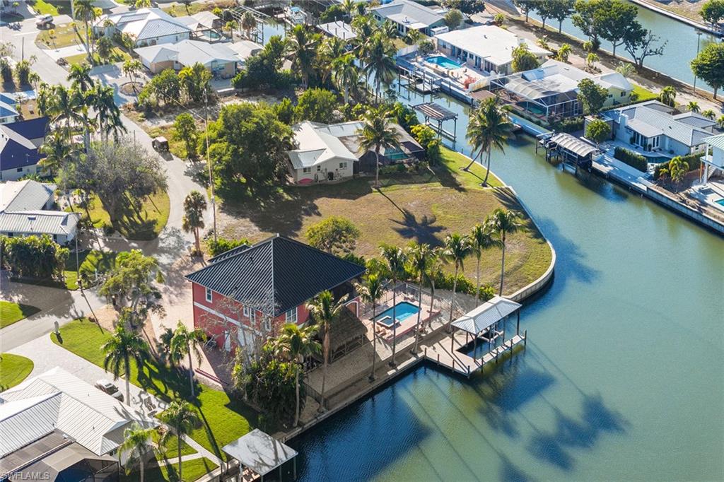 271 Randy Lane Fort Myers Beach, FL 33931 - Photo 16 of 38 an aerial view of a house with a garden and lake view