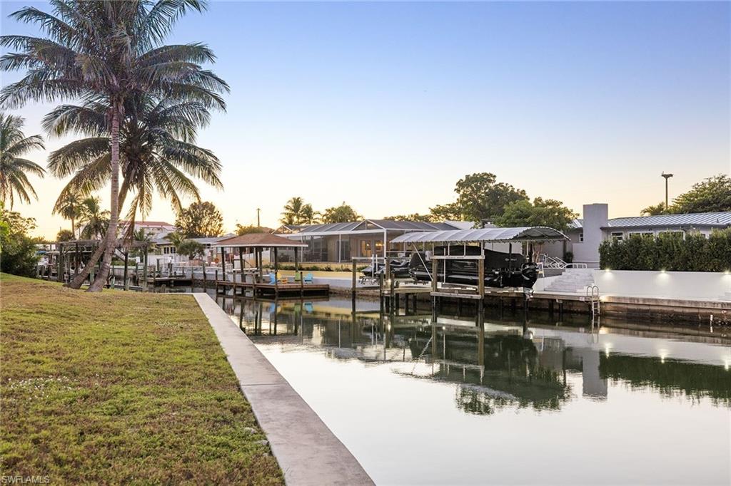 271 Randy Lane Fort Myers Beach, FL 33931 - Photo 22 of 38 a view of swimming pool with outdoor seating and lake view