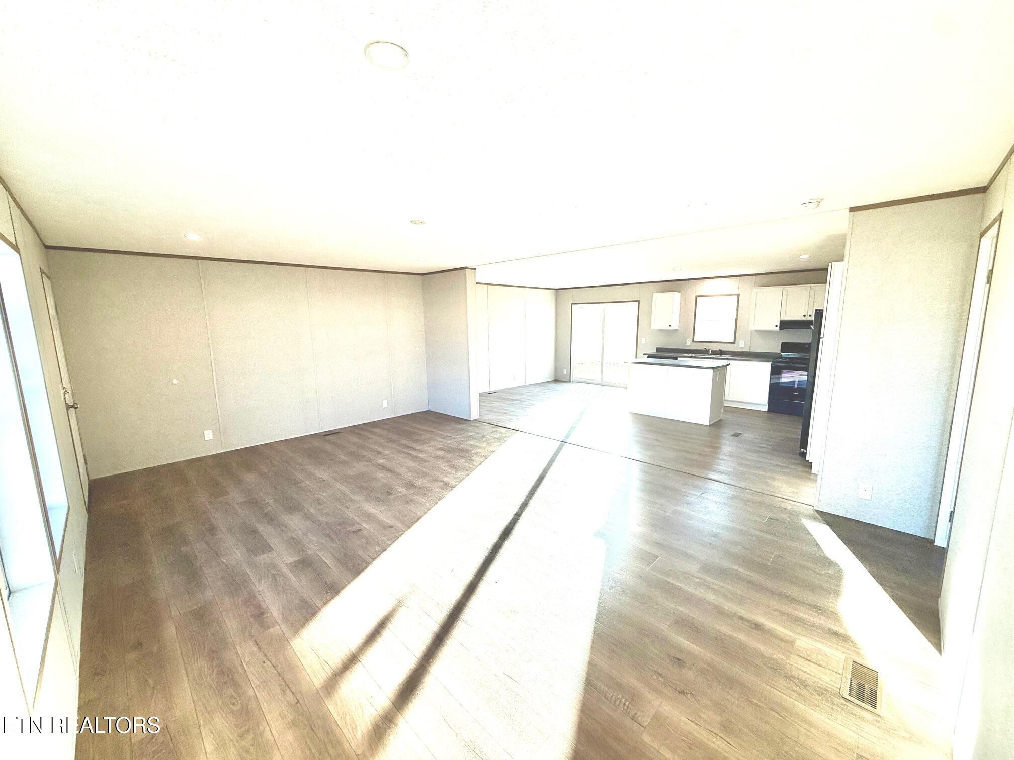 1478 Howell River Road Rutledge, TN 37861 - Photo 8 of 16 a view of empty room with wooden floor and fan