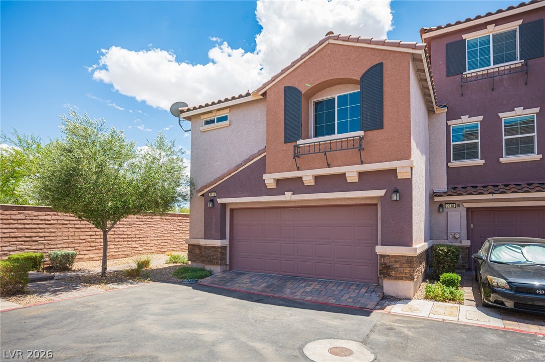 9916 Sable Point Street Las Vegas, NV 89178 - Photo 12 of 73 A terracotta-toned exterior with wrought iron accents and a stone veneer base offers welcoming curb appeal.