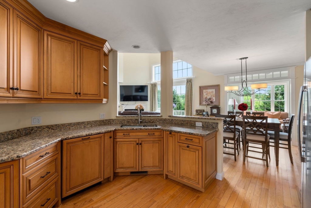 7 English Cmns, Unit 7 Topsfield, MA 01983 - Photo 11 of 36 a kitchen with a sink cabinets and wooden floor