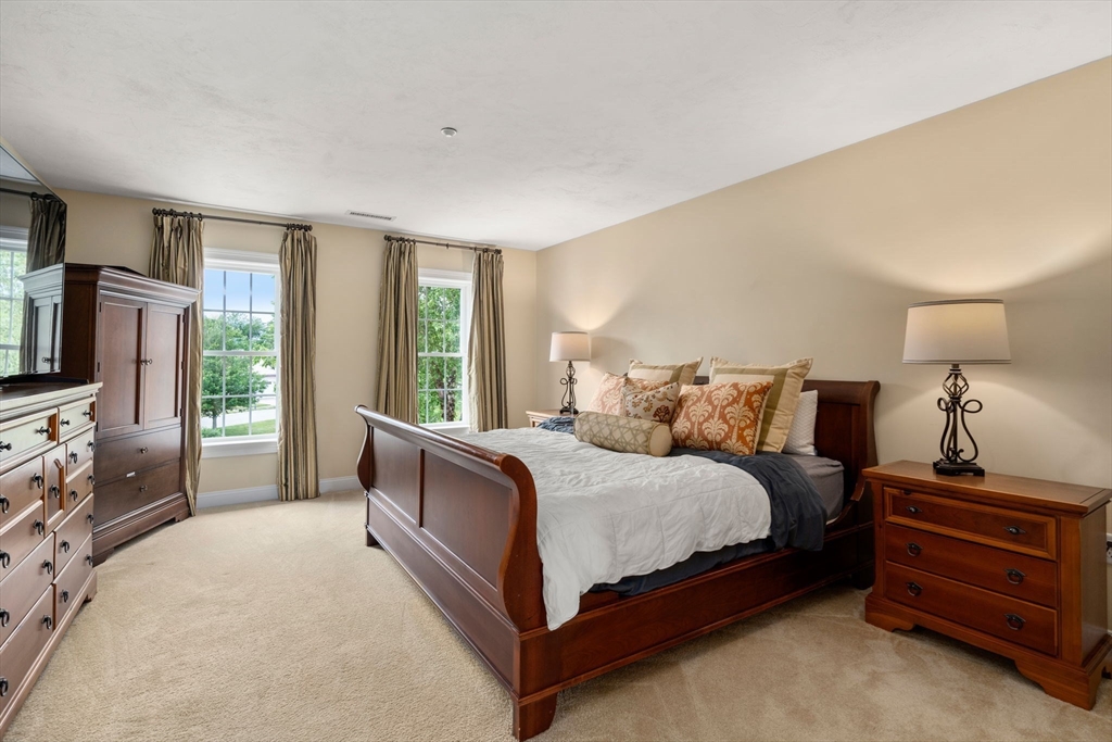 7 English Cmns, Unit 7 Topsfield, MA 01983 - Photo 18 of 36 a bedroom with a bed and a flat screen tv