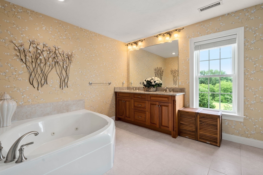 7 English Cmns, Unit 7 Topsfield, MA 01983 - Photo 19 of 36 a bathroom with a tub sink and window