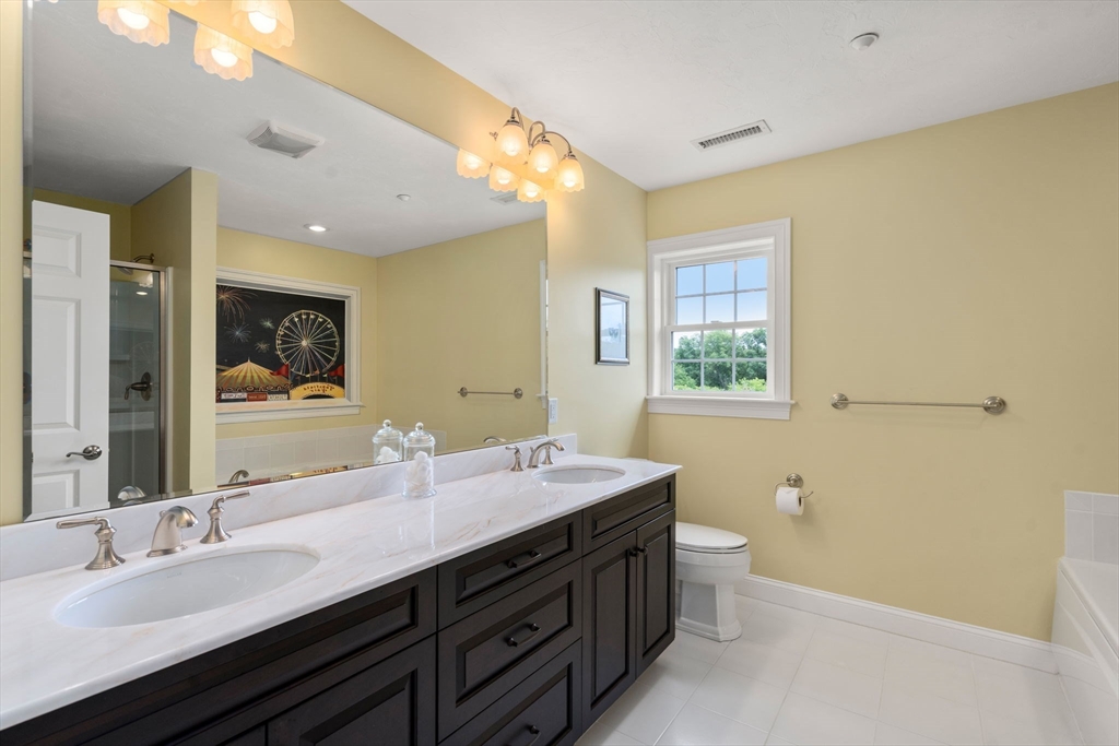 7 English Cmns, Unit 7 Topsfield, MA 01983 - Photo 22 of 36 a bathroom with a double vanity sink mirror and toilet