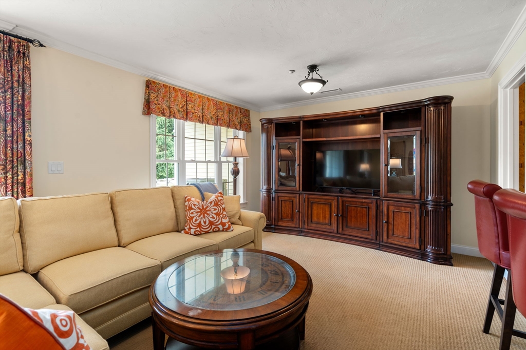 7 English Cmns, Unit 7 Topsfield, MA 01983 - Photo 23 of 36 a living room with furniture and a flat screen tv