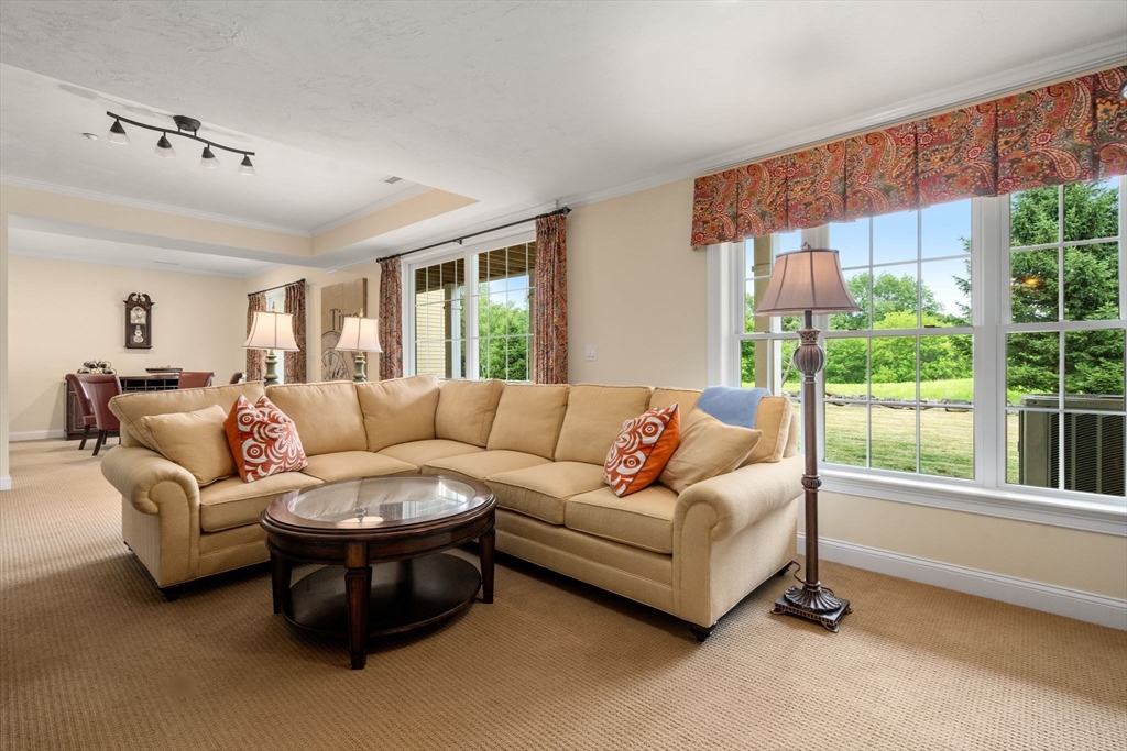7 English Cmns, Unit 7 Topsfield, MA 01983 - Photo 24 of 36 a living room with furniture and a large window