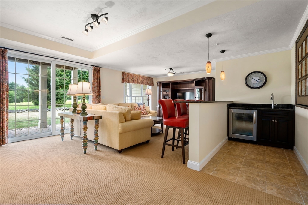7 English Cmns, Unit 7 Topsfield, MA 01983 - Photo 26 of 36 a living room with furniture and a large window