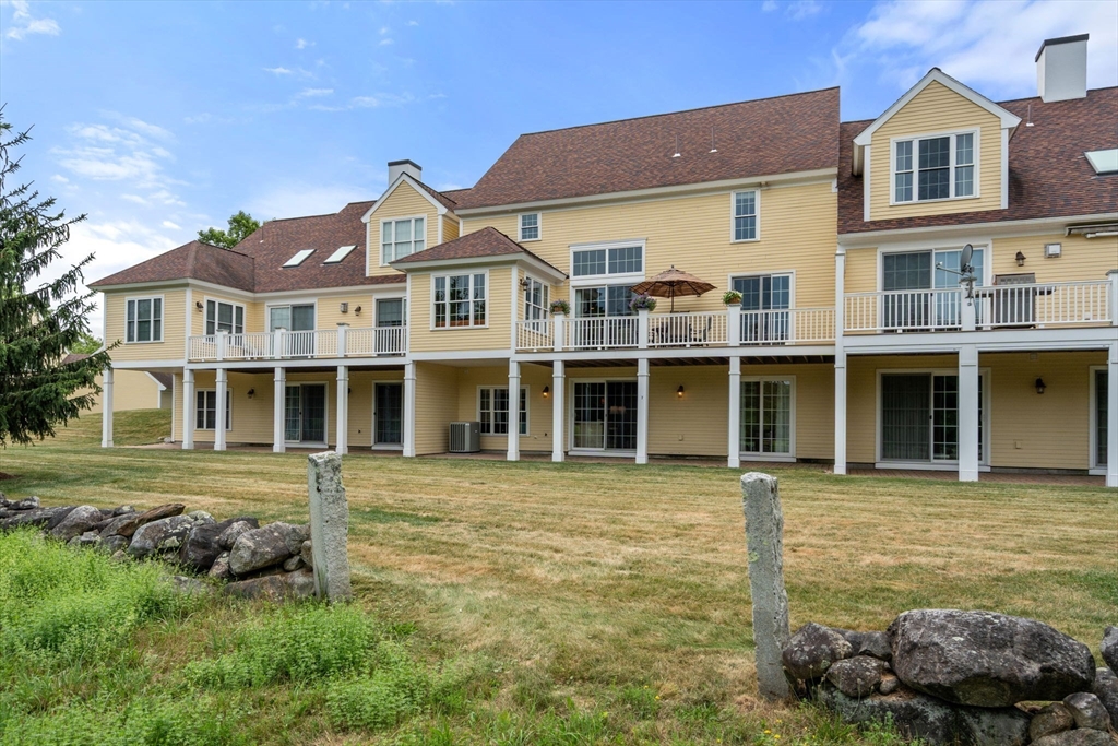 7 English Cmns, Unit 7 Topsfield, MA 01983 - Photo 30 of 36 a front view of a house with a garden