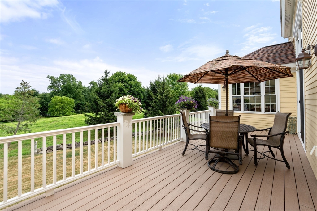 7 English Cmns, Unit 7 Topsfield, MA 01983 - Photo 31 of 36 a view of a chair and table on the deck