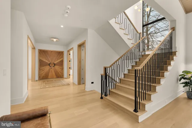 a dining room with furniture a chandelier and wooden floor