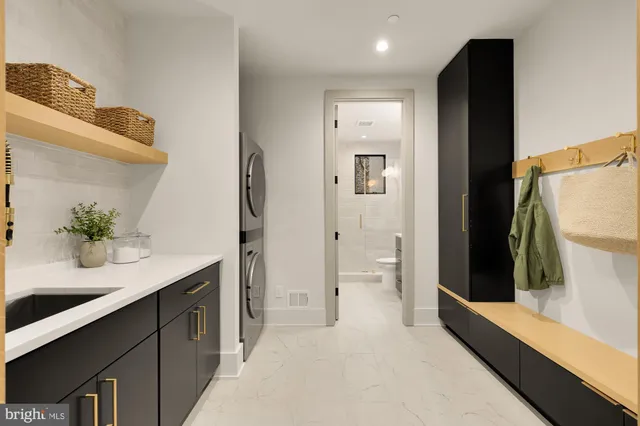 a view of a hallway with wooden floor and a bathroom