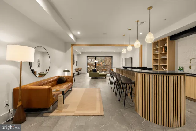 a living room with furniture a table and chairs