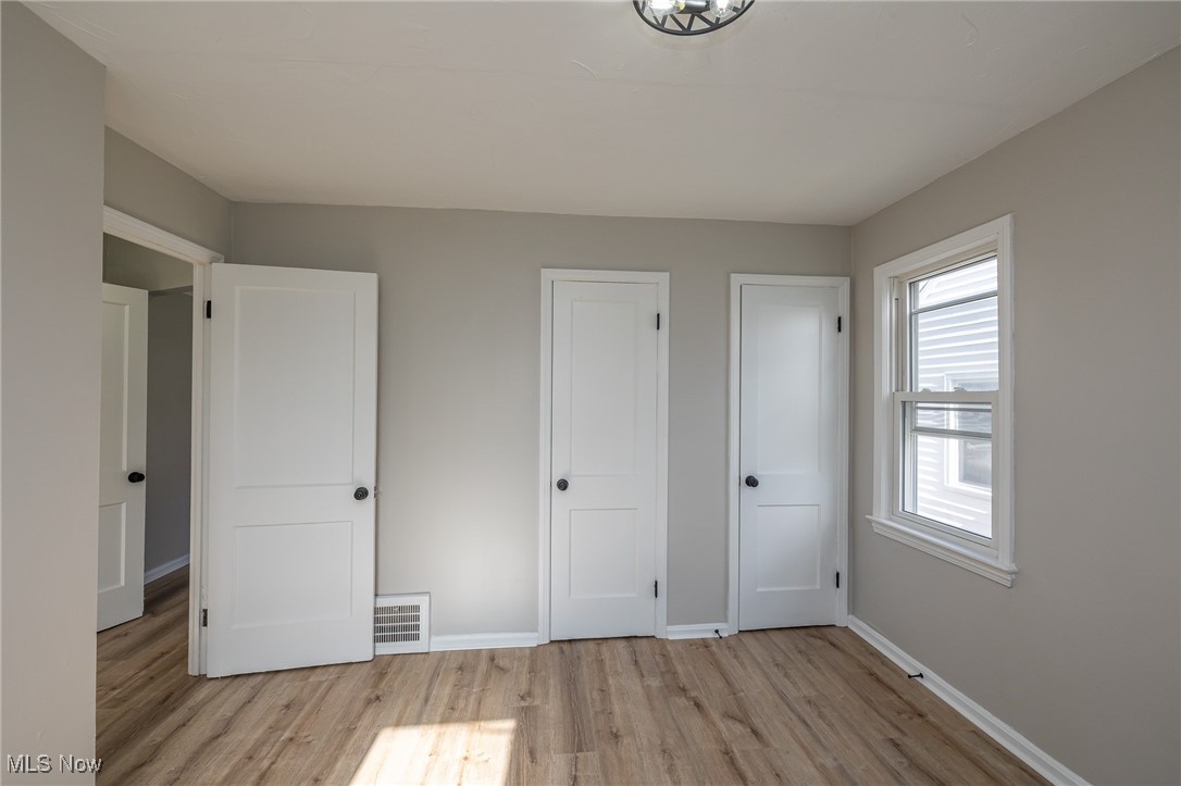 16002 Turney Road Maple Heights, OH 44137 - Photo 17 of 29 Unfurnished bedroom featuring light wood-type flooring and a closet