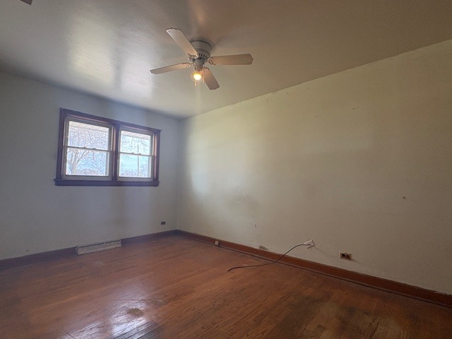 10706 Oak Avenue Chicago Ridge, IL 60415 - Photo 7 of 15 an empty room with a chandelier fan and windows