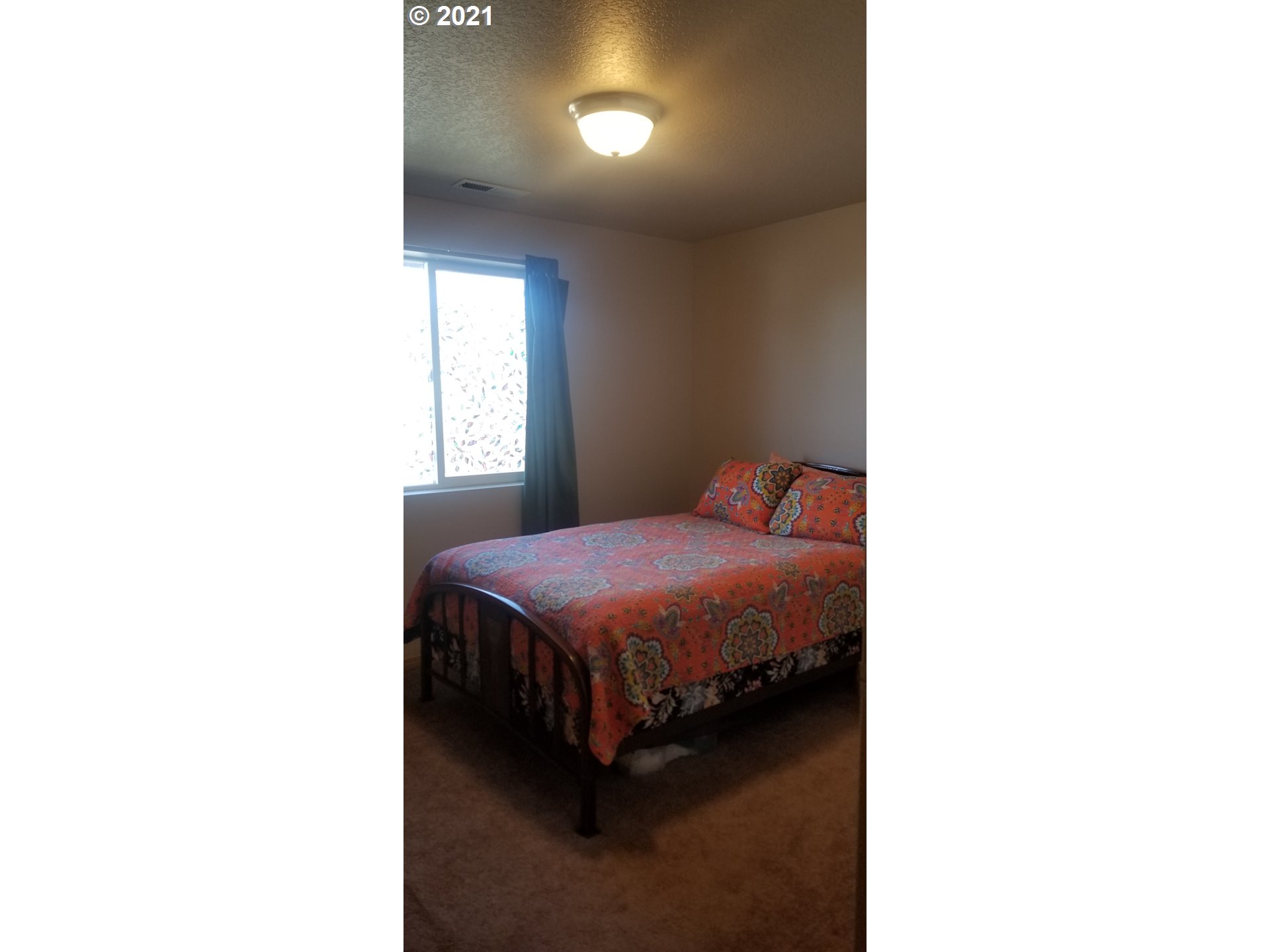 335 Southeast 3rd Street Irrigon, OR 97844 - Photo 12 of 29 a spacious bedroom with a bed and a window