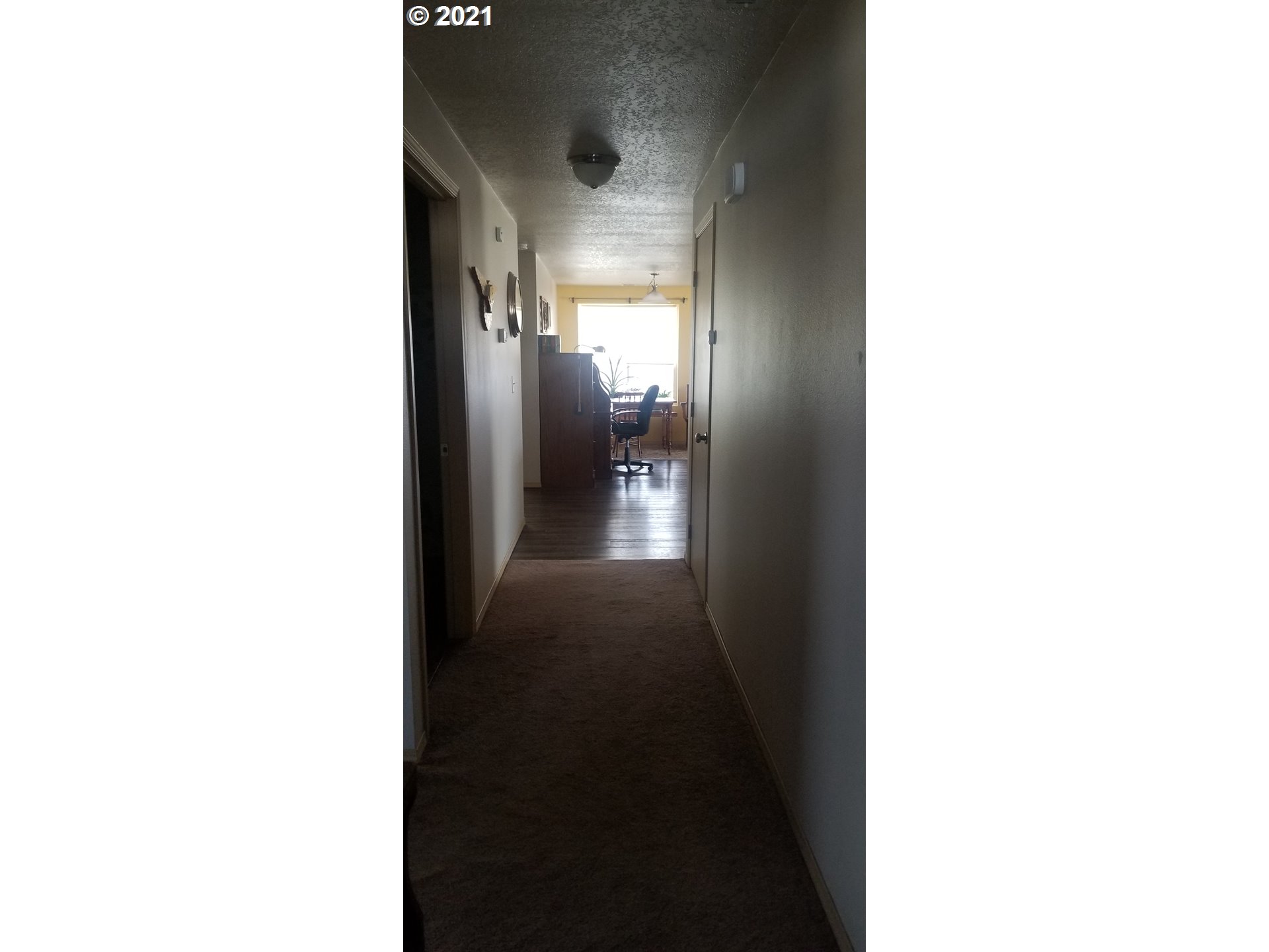 335 Southeast 3rd Street Irrigon, OR 97844 - Photo 13 of 29 a view of a hallway with wooden floor