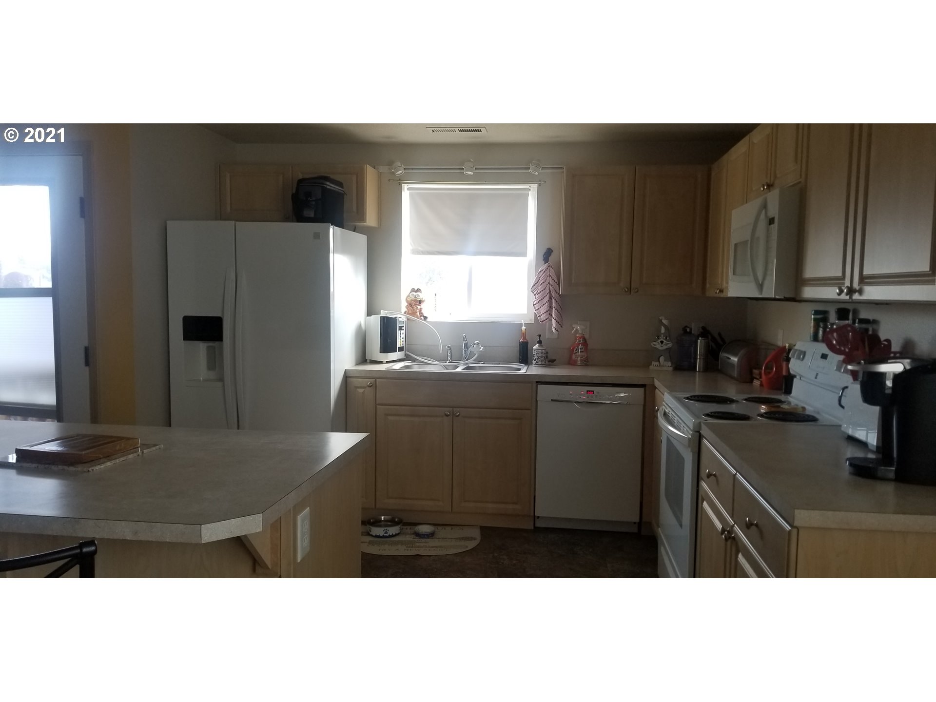 335 Southeast 3rd Street Irrigon, OR 97844 - Photo 6 of 29 a kitchen with a refrigerator and a sink