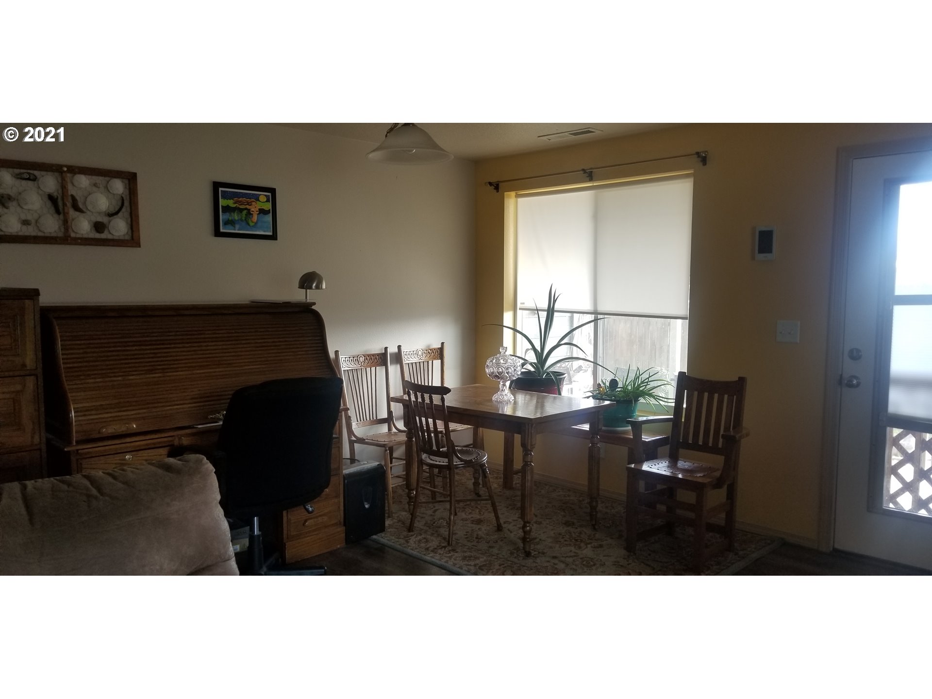 335 Southeast 3rd Street Irrigon, OR 97844 - Photo 8 of 29 a view of livingroom and dining room with furniture window and wooden floor