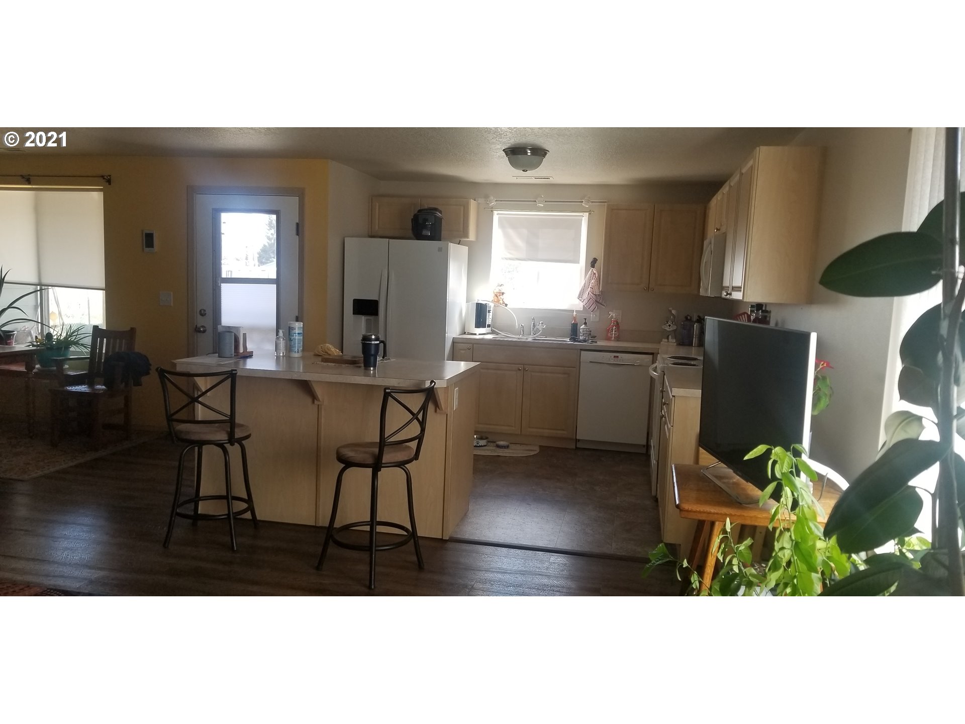 335 Southeast 3rd Street Irrigon, OR 97844 - Photo 9 of 29 a living room with furniture a flat screen tv and a table