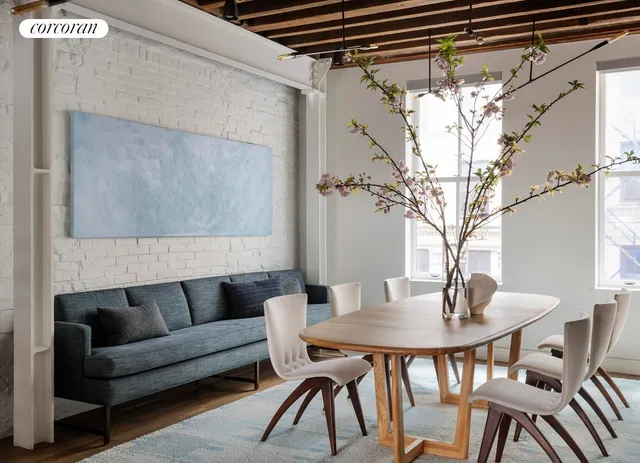a view of a dining room with furniture and wooden floor