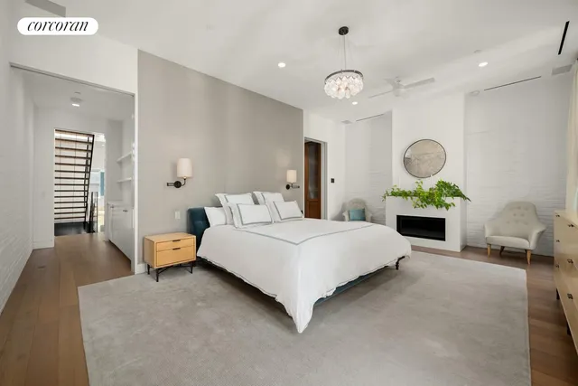 a bedroom with a bed and windows