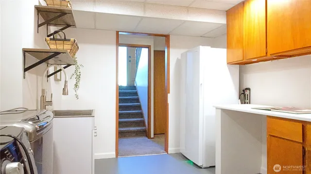 a view of a hallway with wooden floor and entryway