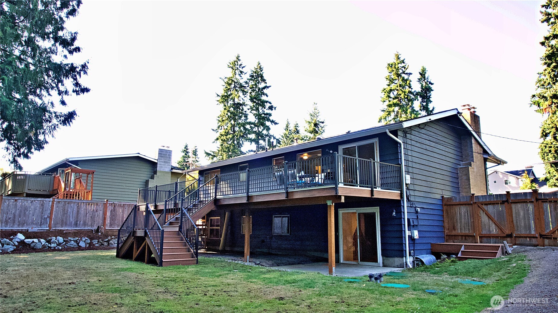 16 234th Place Southeast Bothell, WA 98021 - Photo 30 of 36 a view of a house with a yard potted plants and a large tree