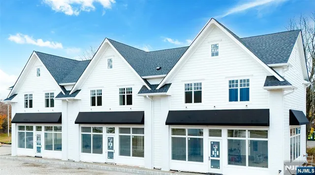 a view of a white house with large windows