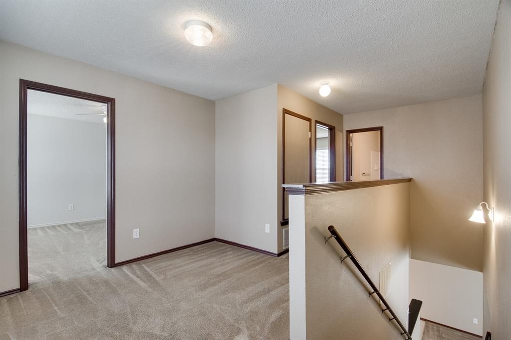 8211 Leaning Oak Court Arlington, TX 76002 - Photo 16 of 26 Unfurnished room featuring light carpet and a textured ceiling
