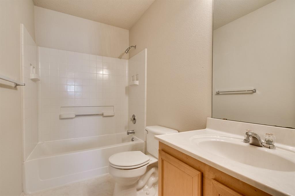 8211 Leaning Oak Court Arlington, TX 76002 - Photo 21 of 26 Full bath featuring shower / bath combination, vanity, light tile patterned flooring, and a textured ceiling