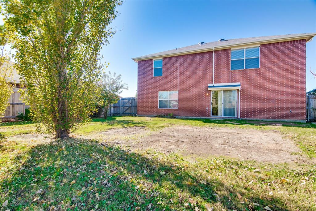 8211 Leaning Oak Court Arlington, TX 76002 - Photo 25 of 26 Back of property with a fenced backyard and brick siding