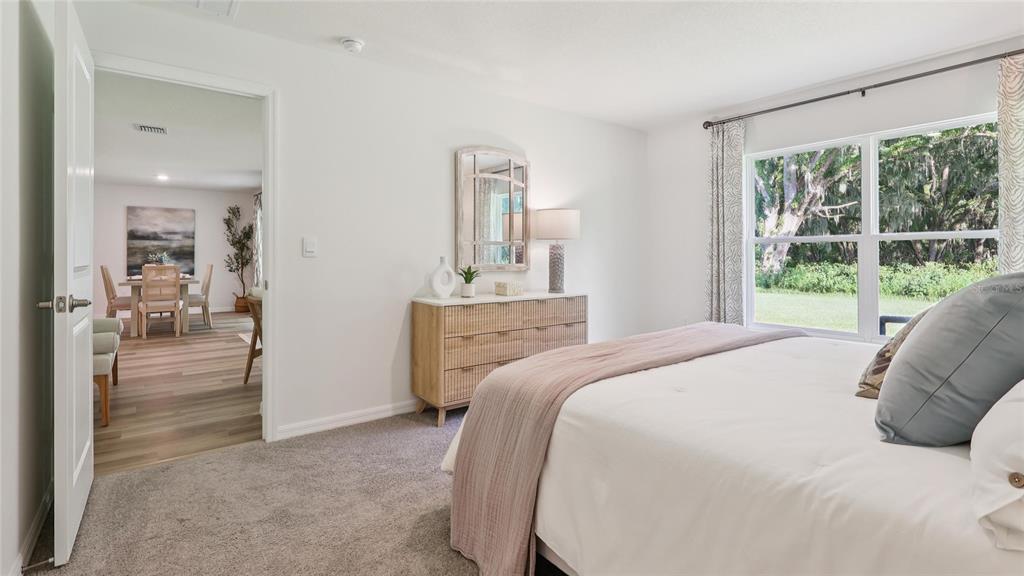 7608 North Oasis Point Citrus Springs, FL 34433 - Photo 13 of 21 a bedroom with a bed and a large window