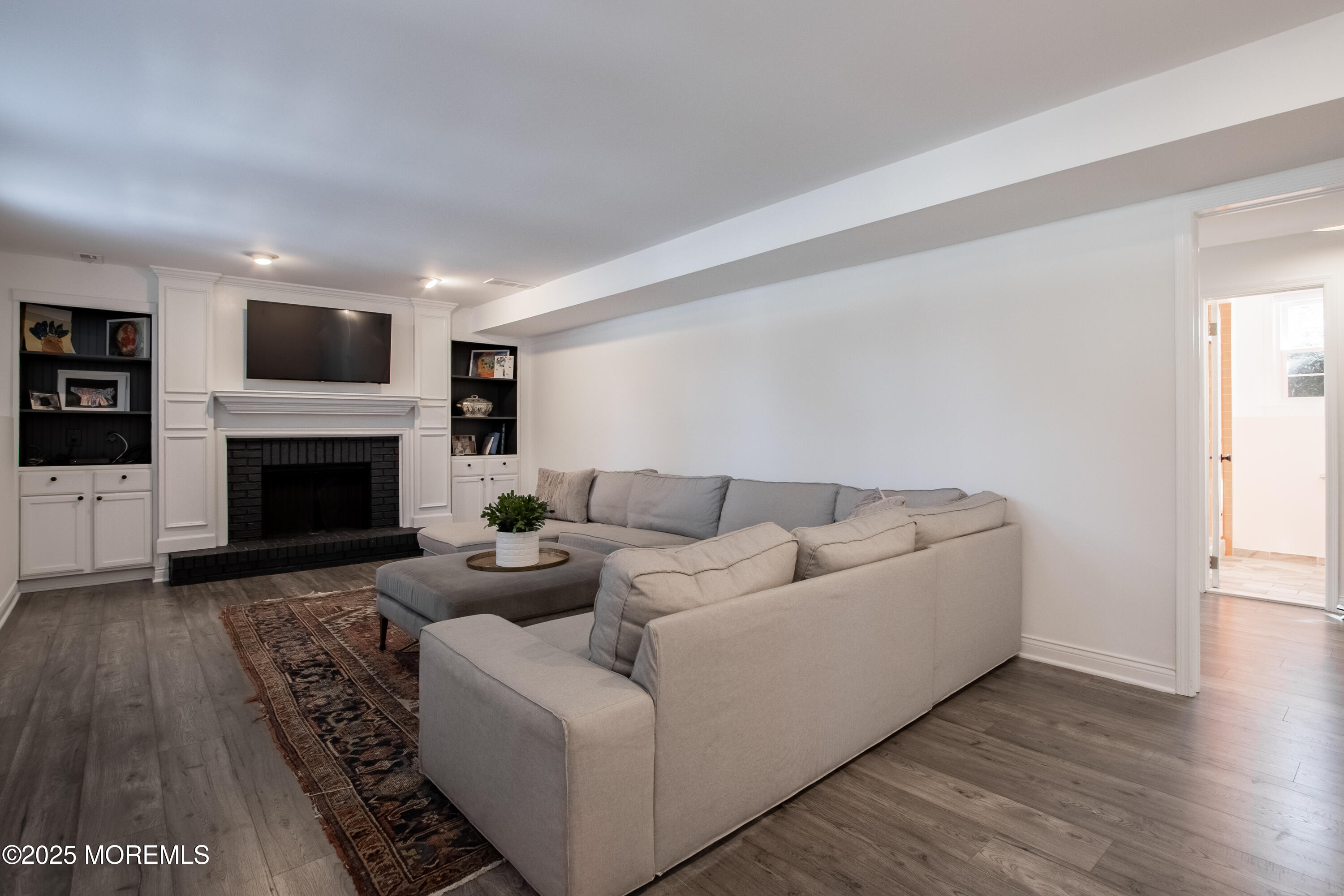 60 Brookside Lane Little Silver, NJ 07739 - Photo 25 of 34 a living room with furniture and a fireplace