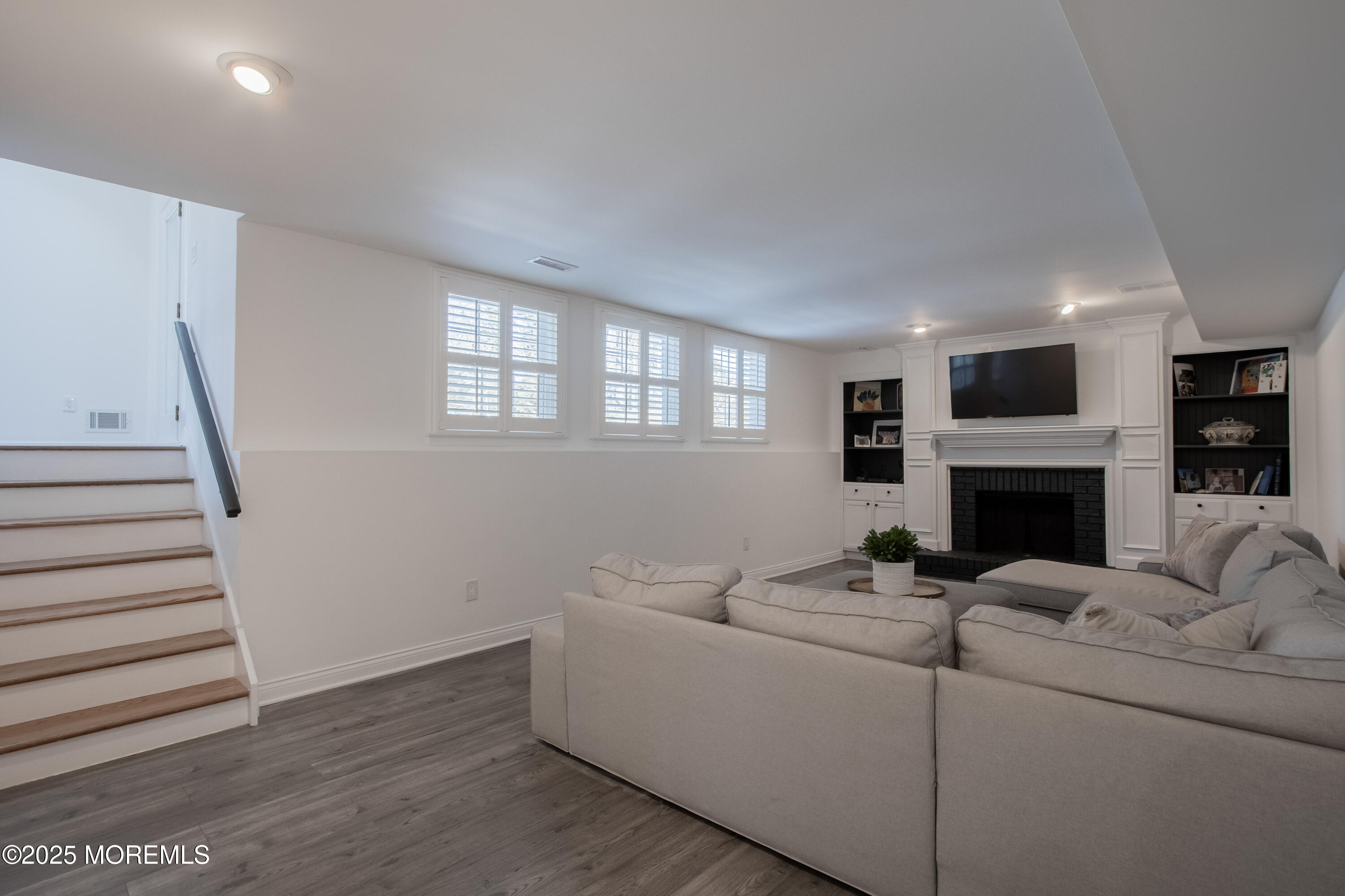 60 Brookside Lane Little Silver, NJ 07739 - Photo 26 of 34 a living room with furniture a fireplace and a flat screen tv