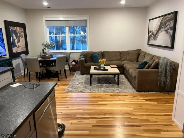 a living room with furniture a rug and a wall painting
