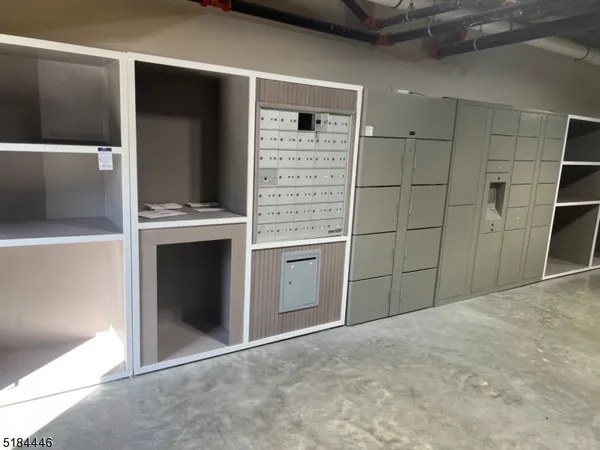 a view of a refrigerator in kitchen and an empty room