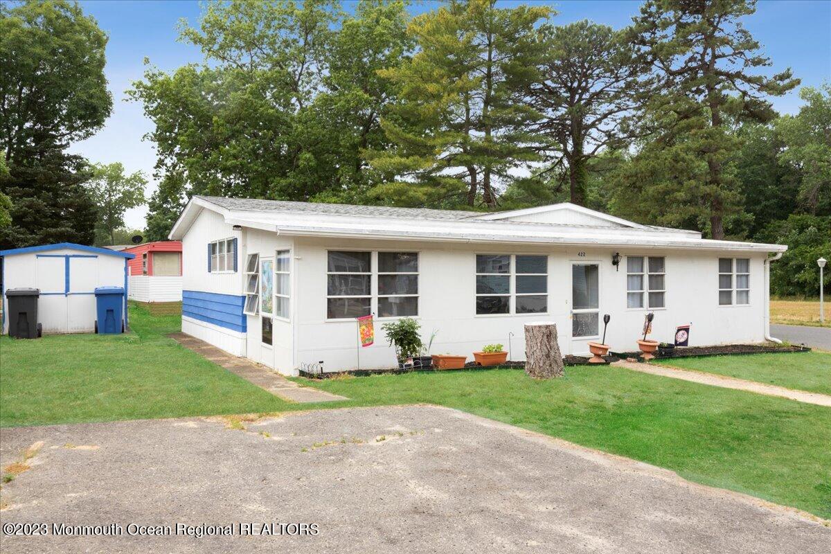 422 Roberts Road Toms River, NJ 08755 - Photo 1 of 18 a front view of a house with a yard and trees