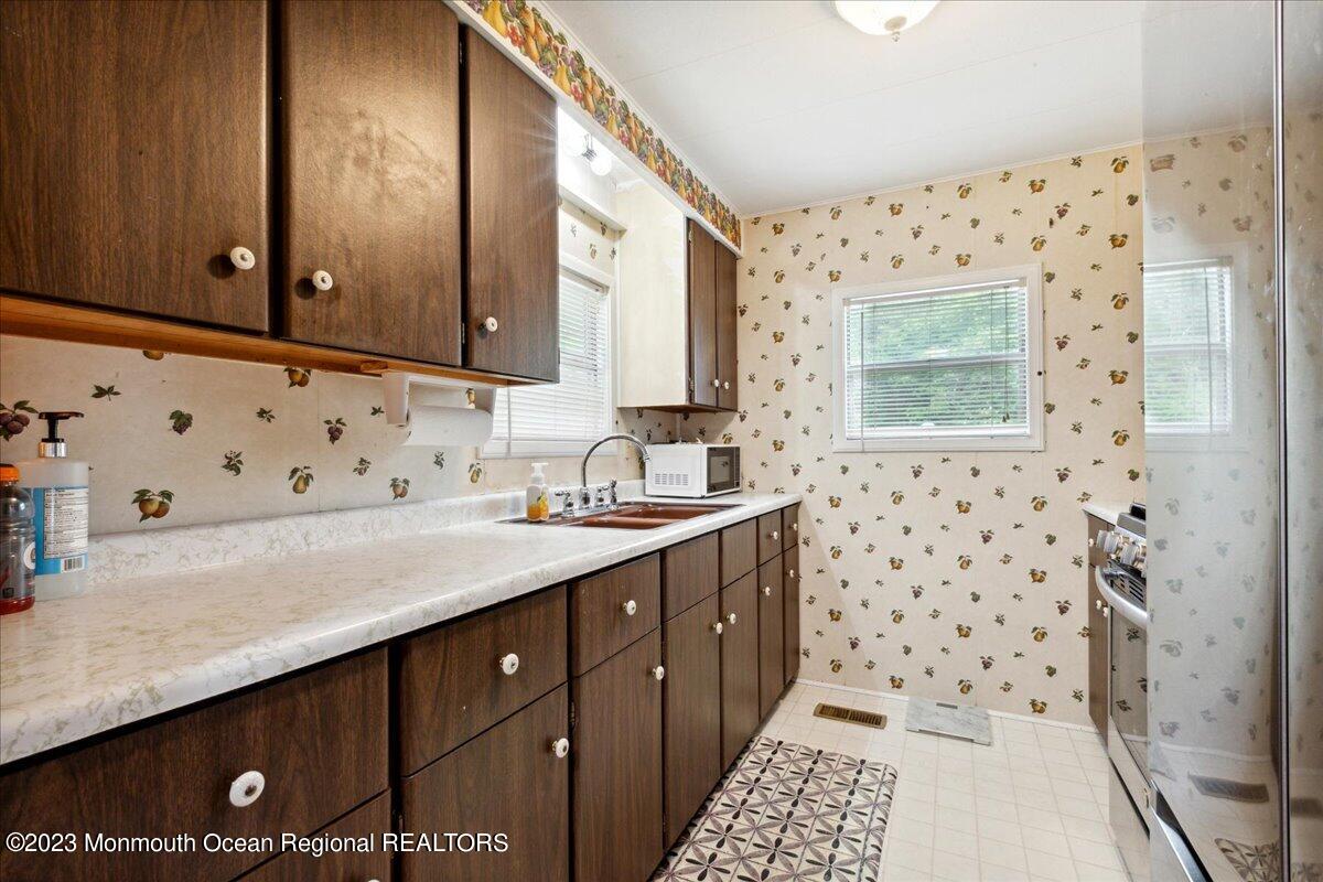422 Roberts Road Toms River, NJ 08755 - Photo 12 of 18 a bathroom with a sink a mirror a vanity and a shower