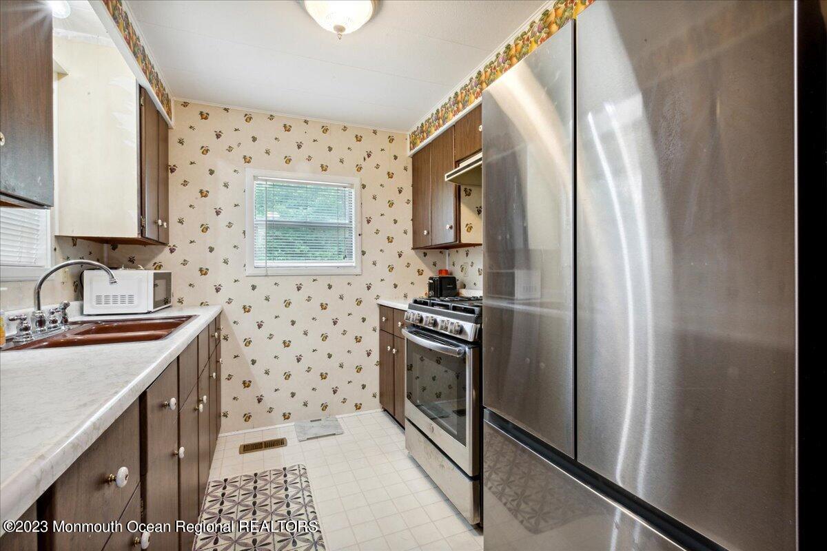 422 Roberts Road Toms River, NJ 08755 - Photo 13 of 18 a kitchen with stainless steel appliances a refrigerator sink and stove