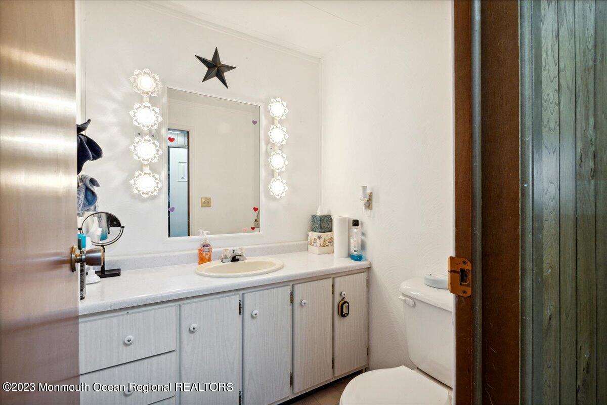 422 Roberts Road Toms River, NJ 08755 - Photo 15 of 18 a bathroom with a sink a toilet and a mirror