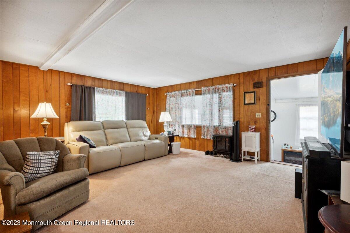 422 Roberts Road Toms River, NJ 08755 - Photo 10 of 18 a living room with furniture and a chandelier
